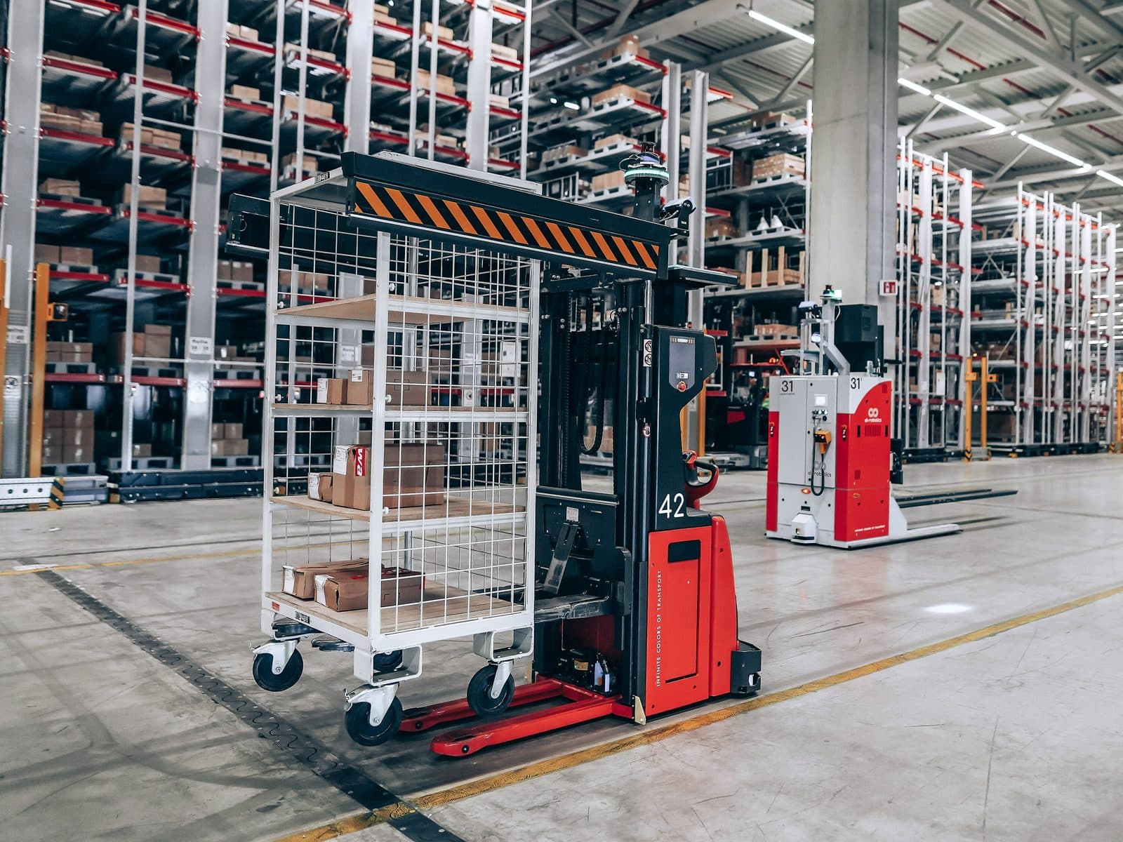 ek robotics autonomous vehicles between racks in a distribution center